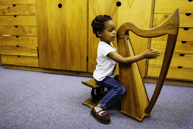Montessori School of Pensacola student playing the harp